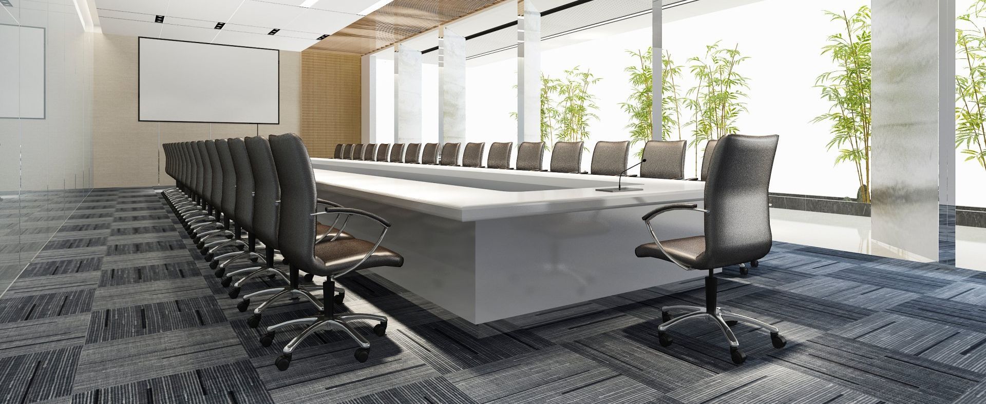 A conference room with a long table and chairs.
