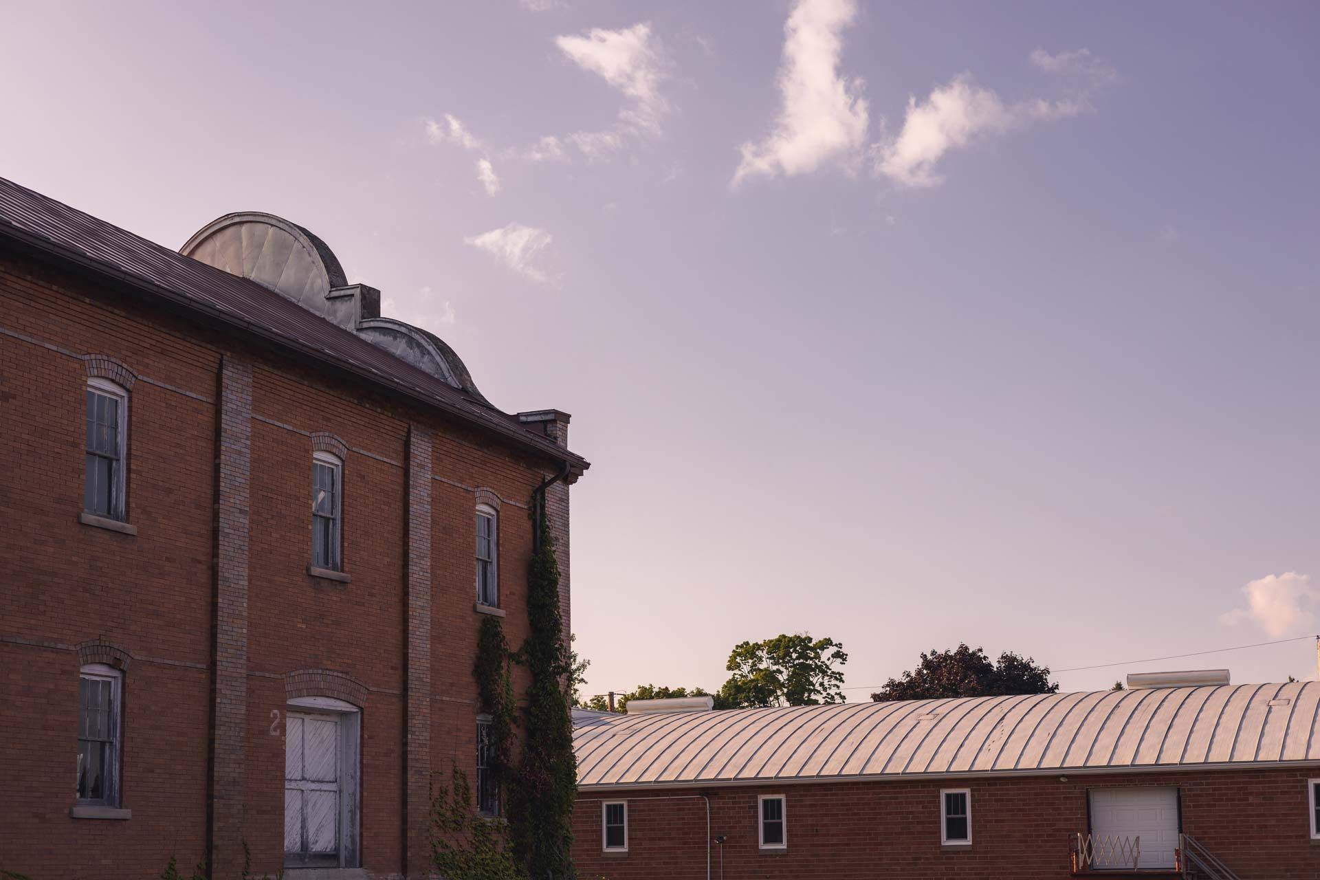 Red brick buildings under a partly cloudy sky.