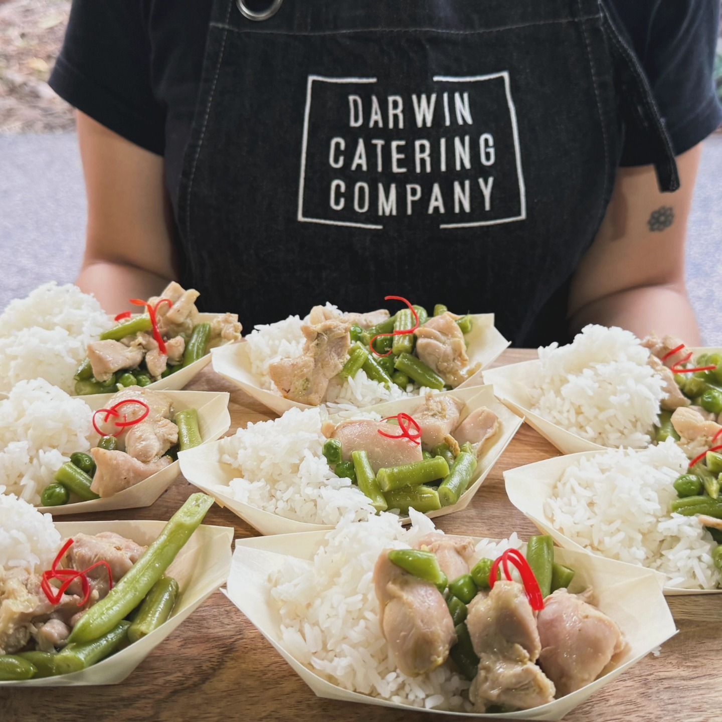 A Person Wearing an Apron That Says Darwin Catering Company — Darwin Catering Company in Brinkin, NT