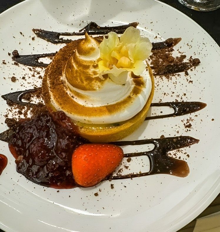A White Plate Topped With a Dessert and a Strawberry — Darwin Catering Company in Brinkin, NT