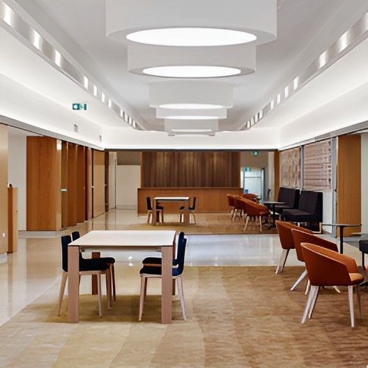 A Long Hallway With Tables and Chairs in It — Darwin Catering Company in Brinkin, NT