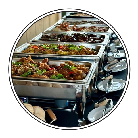A Person is Taking a Tray of Food From a Buffet — Darwin Catering Company in Brinkin, NT