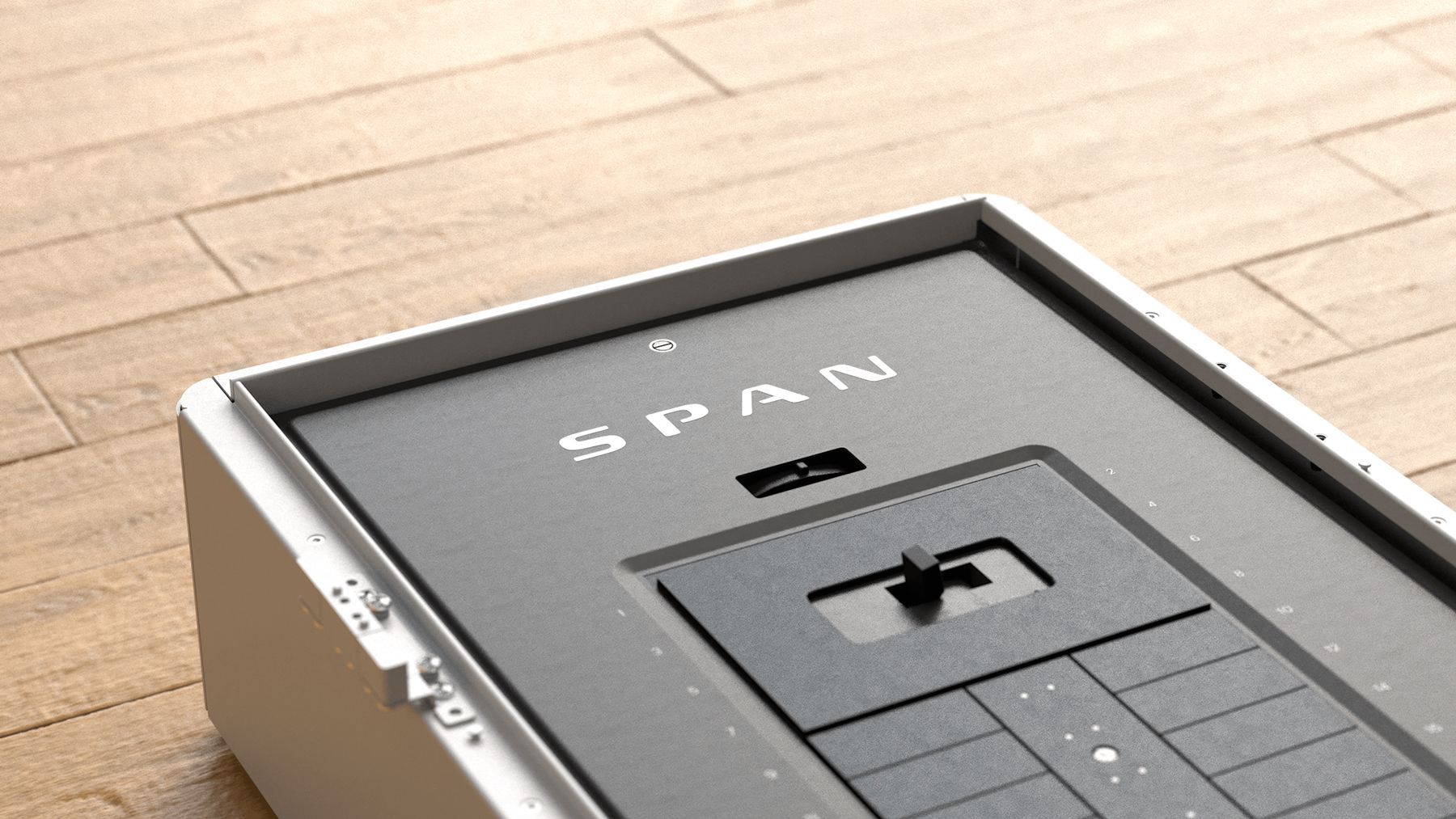 Gray and white SPAN device on a wood surface, with a slider and buttons.
