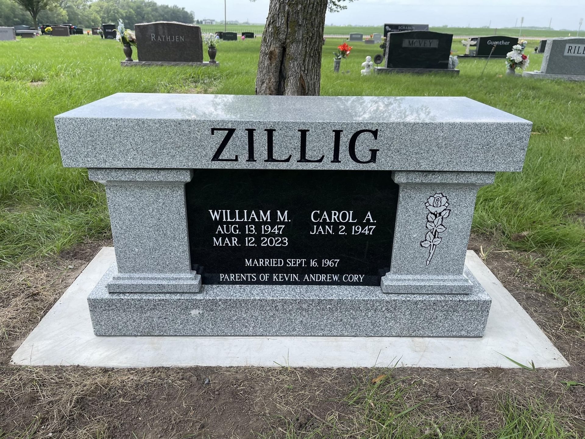 Granite headstone in cemetery, inscription 