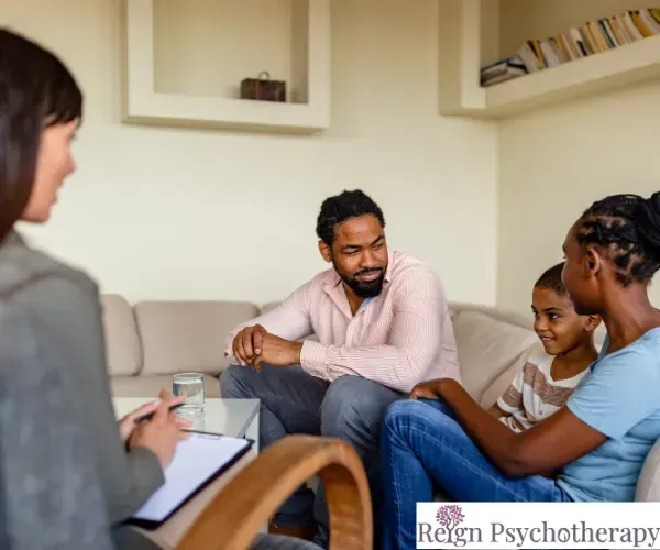A person sits on a sofa in a relaxed living room setting, looking