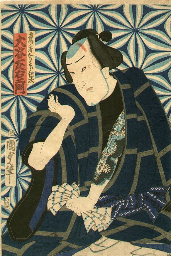 A man has a full sleeve tattoo on his arm and shoulder.