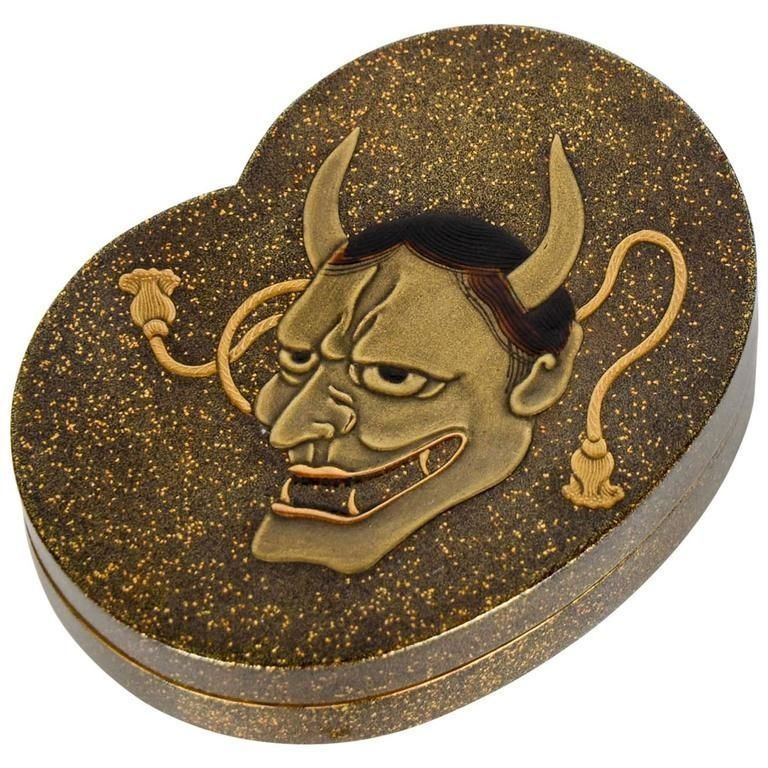 A heart shaped box with a devil face on it