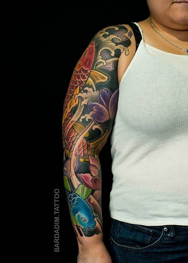 A woman has a full sleeve tattoo on her arm