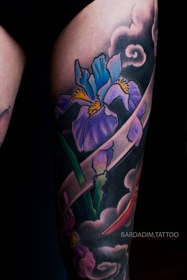 A tattoo of a purple flower on a person 's leg