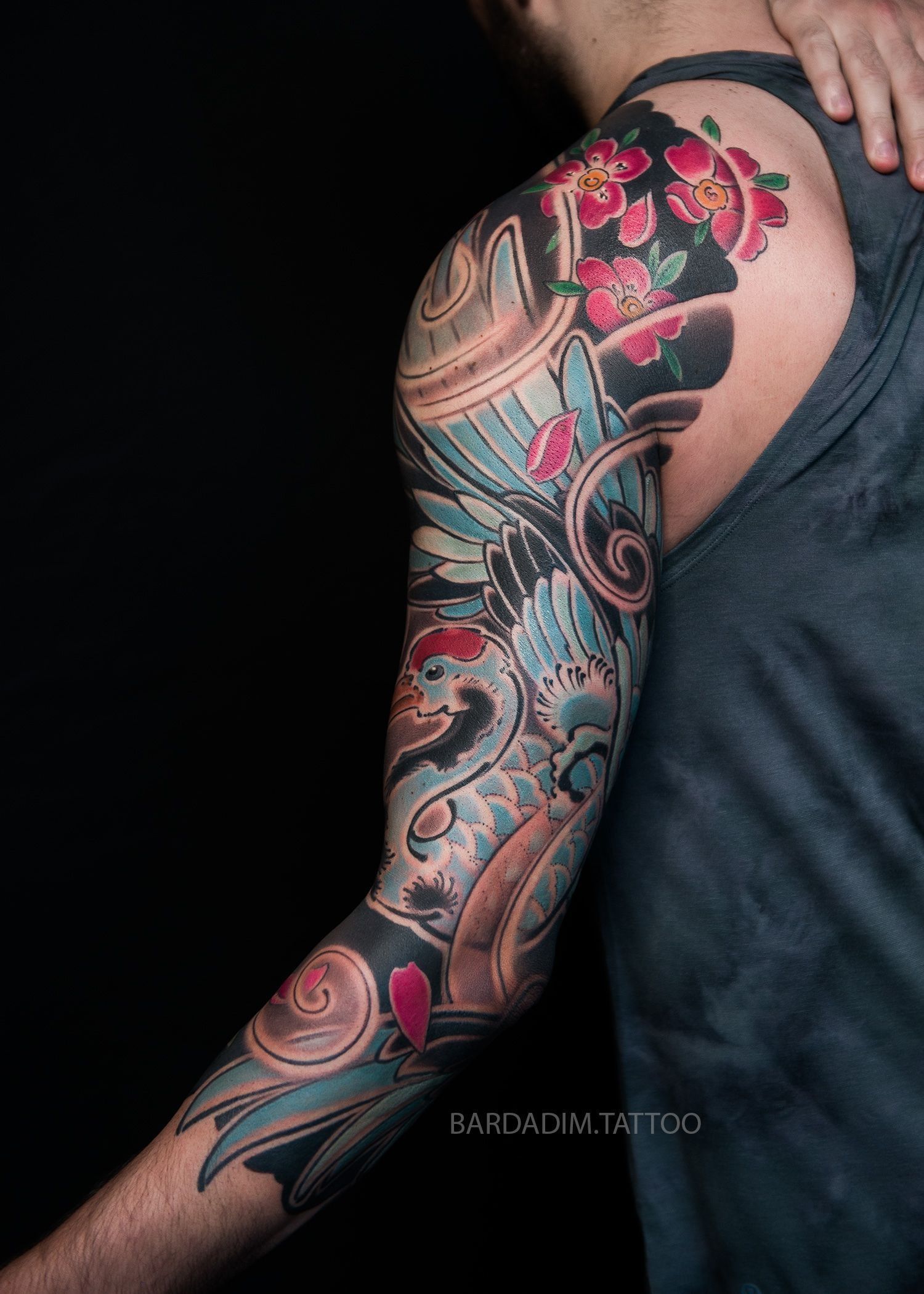 A man with a tattoo on his arm and shoulder.