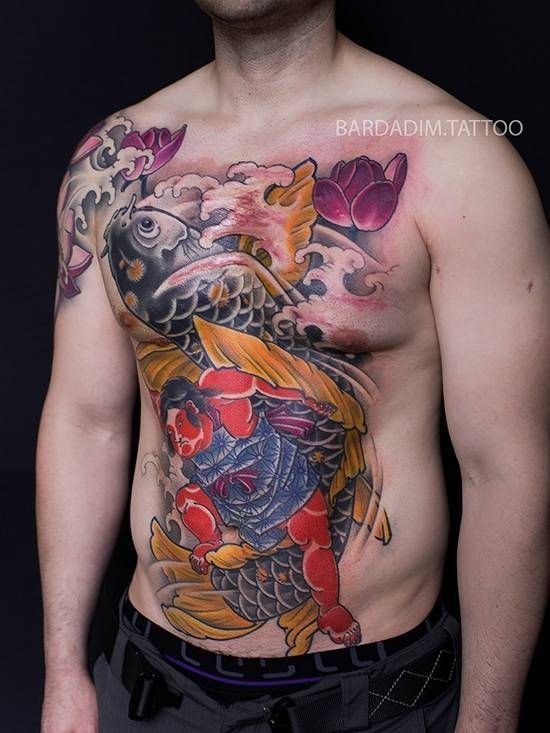A man with a tattoo on his chest and stomach.