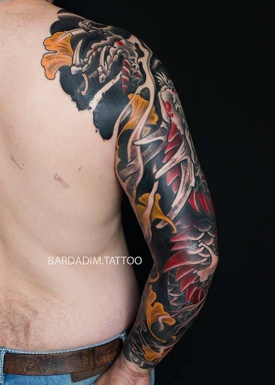 A man with a tattoo on his arm and back.