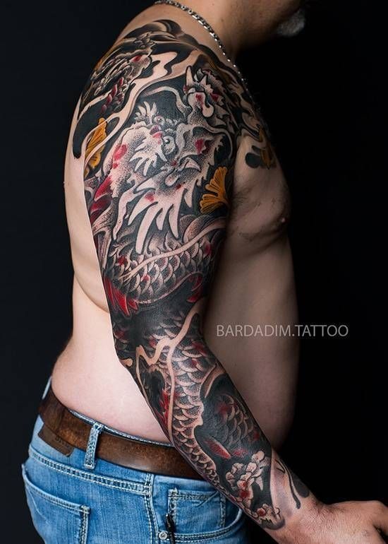 A man with a full sleeve tattoo on his arm.