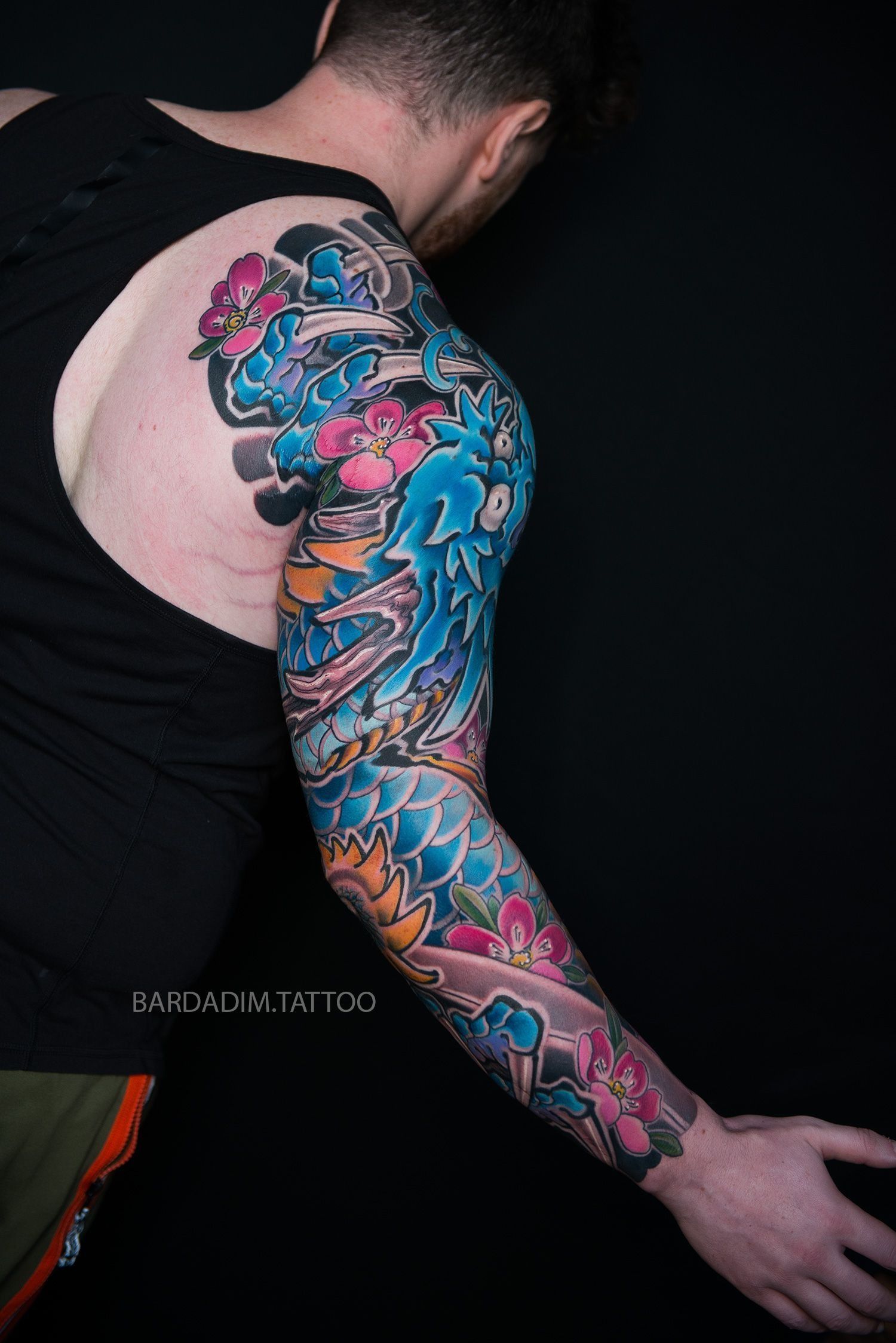 A man with a full sleeve tattoo on his arm.