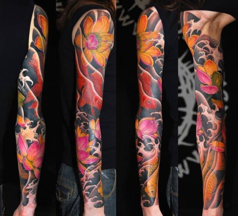A woman has a full sleeve tattoo of flowers and waves