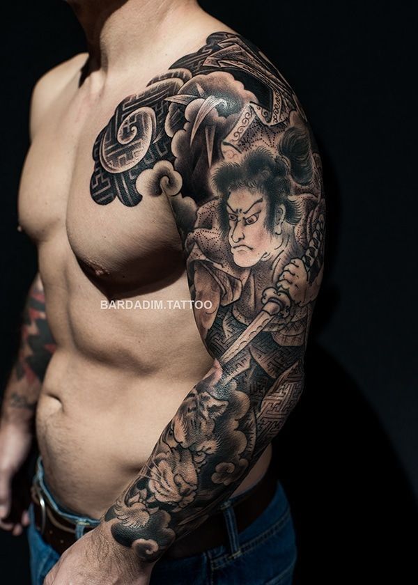 A man with a tattoo on his arm and chest.