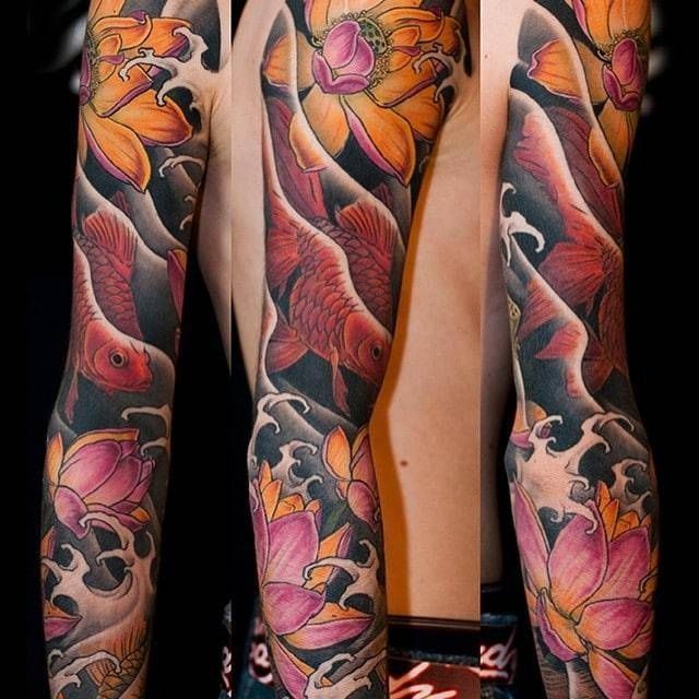 A man has a full sleeve tattoo of flowers and fish