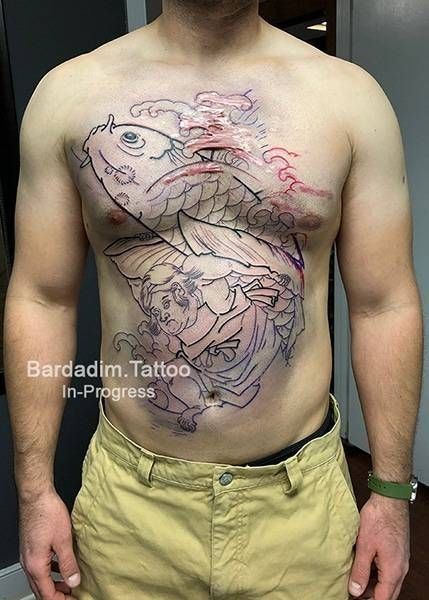 A man has a tattoo of a fish on his chest.