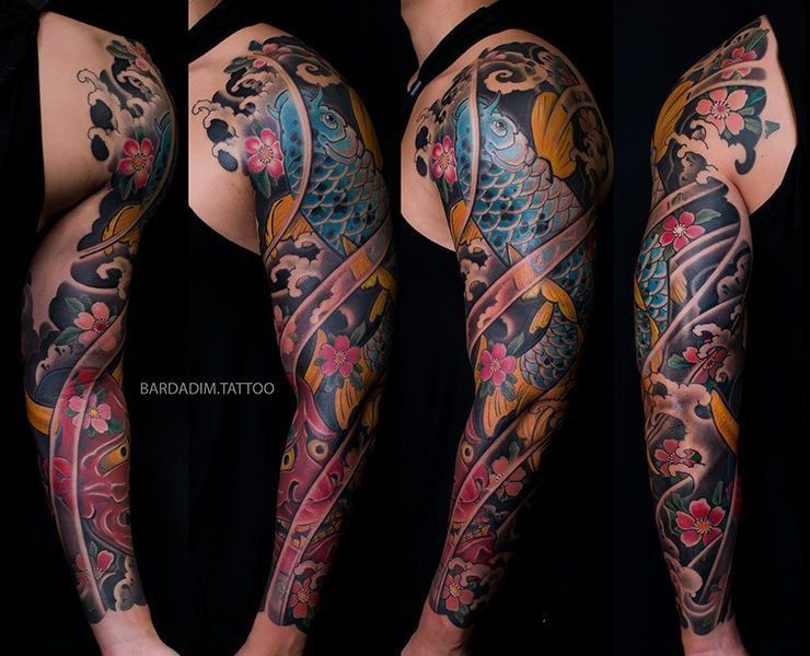 A man has a colorful tattoo on his arm and shoulder.
