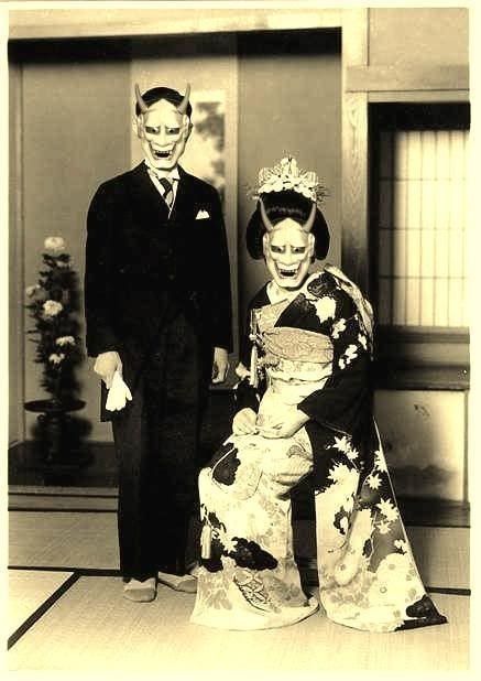 A black and white photo of a man and woman wearing masks