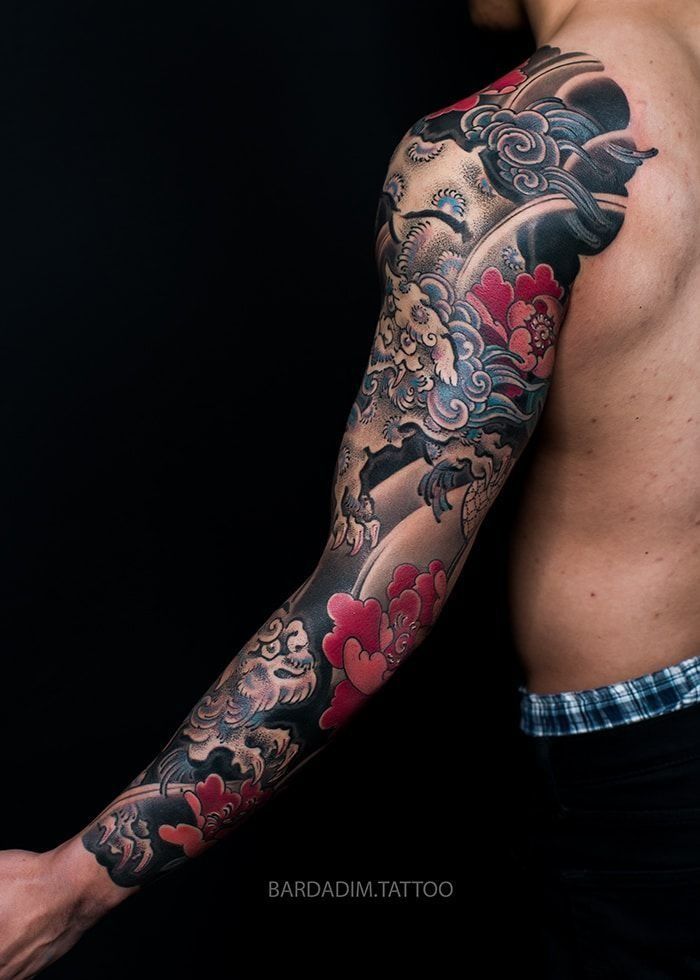 A man with a full sleeve tattoo on his arm.