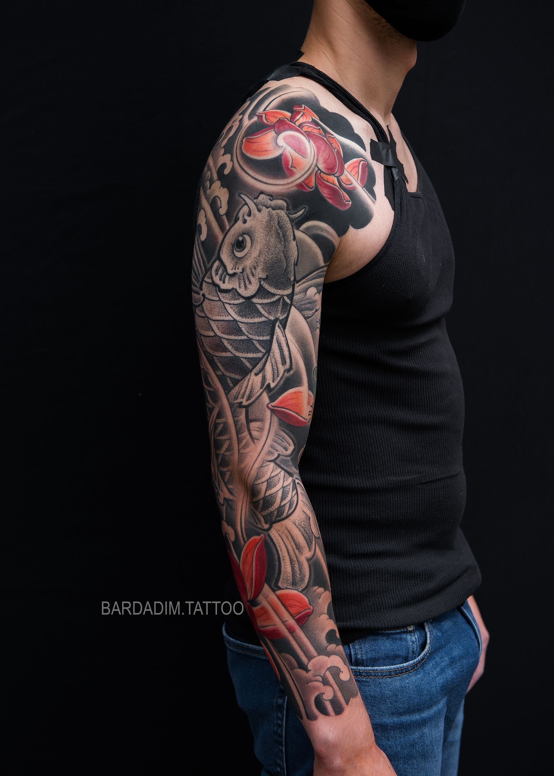 A man with a full sleeve tattoo on his arm.