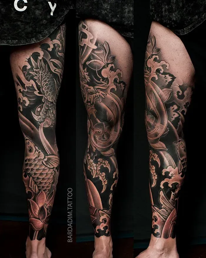 Leg sleeve tattoo: koi fish, lotus, waves, and dragon in black and grey, Japanese style.
