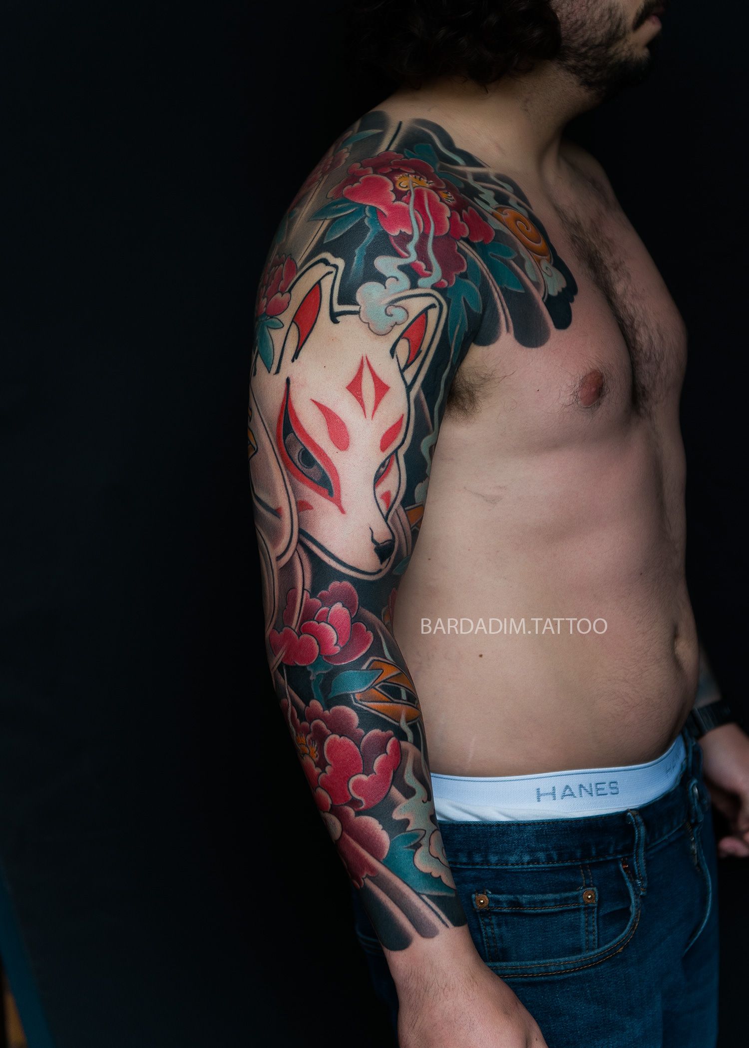 Japanese kitsune mask full sleeve tattoo with peonies, front view, bold traditional irezumi tattoo design