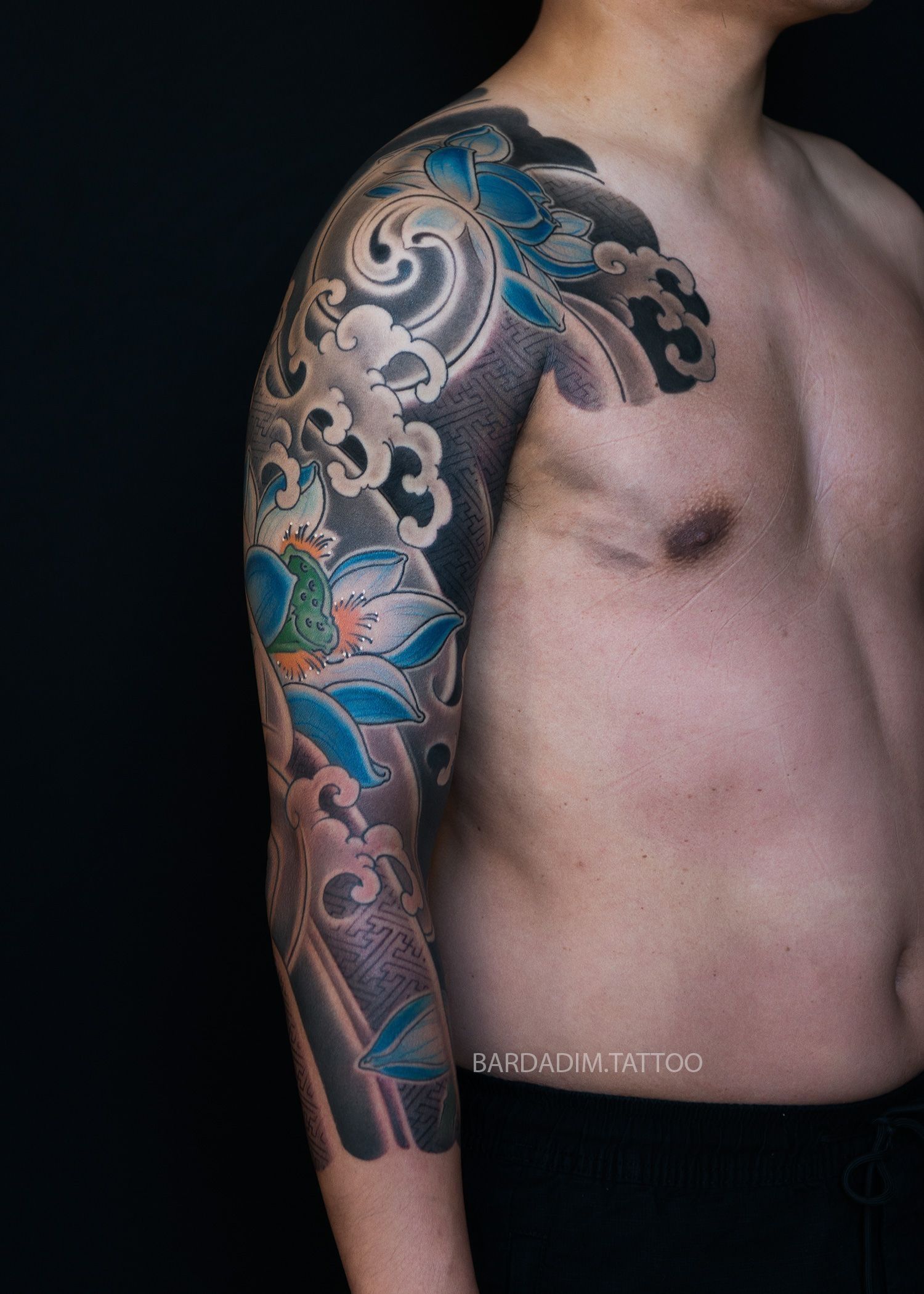 Three-quarter sleeve Irezumi tattoo with lotus flower and sayagata background pattern by Bardadim Tattoo Studio