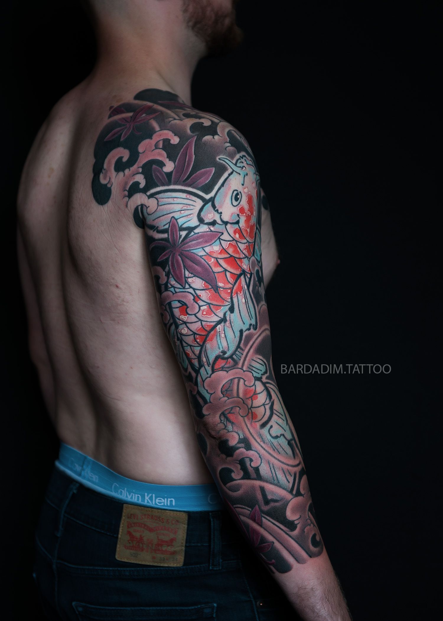 Orange koi fish Japanese tattoo sleeve symbolizing perseverance, balance, and inner strength. Traditional Irezumi by Bardadim in New York.