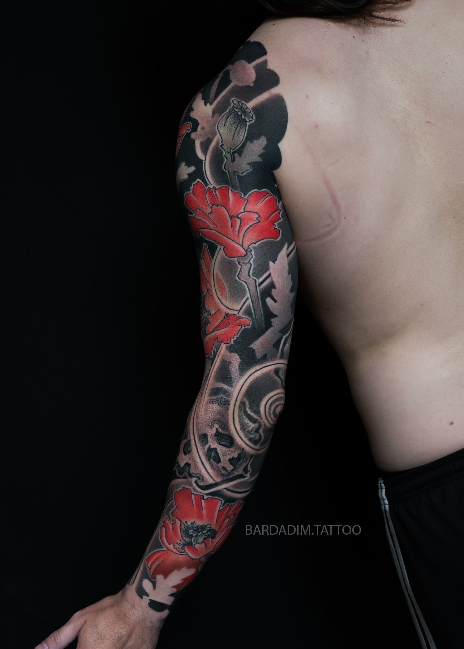 A man with a full sleeve tattoo on his arm.