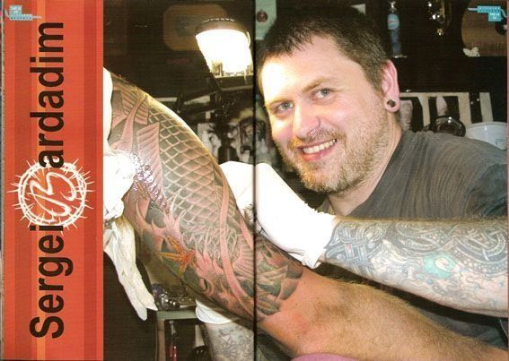 A man is getting a tattoo on his arm with the name sergei sardadim on the bottom