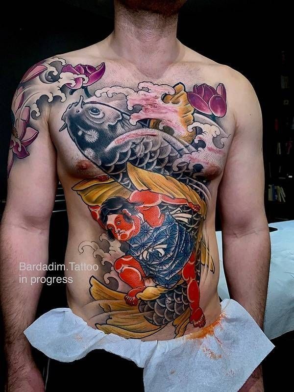 Man with a colorful koi fish chest irezumi tattoo at Bardadim Tattoo. 