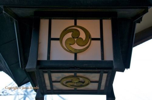 A lantern with a symbol on it is hanging from the ceiling