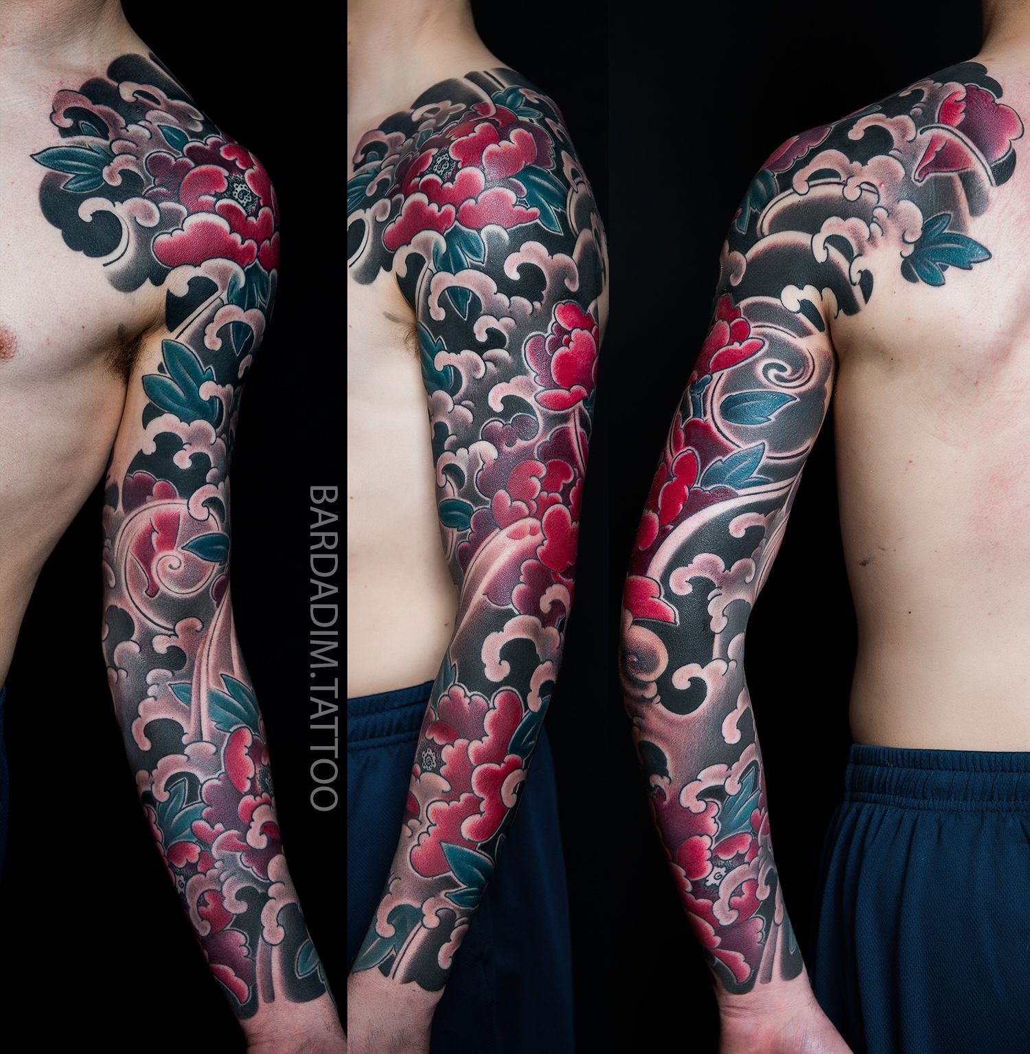 Tattoo sleeve with floral and cloud design in red, black, and blue, on a person's arm and shoulder.
