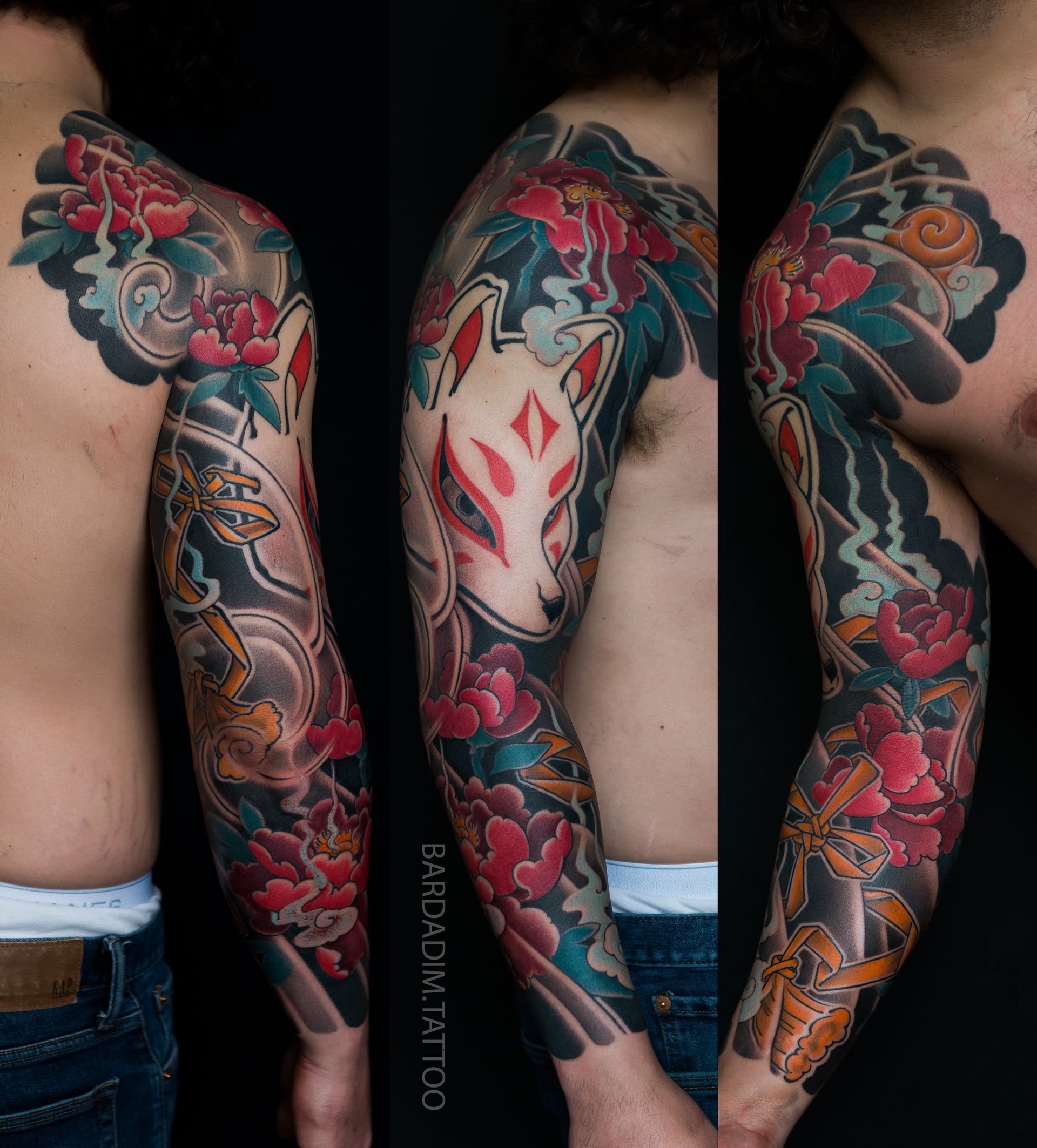 Colorful sleeve tattoo: Kitsune mask, red flowers, blue clouds, and intricate details on arm.