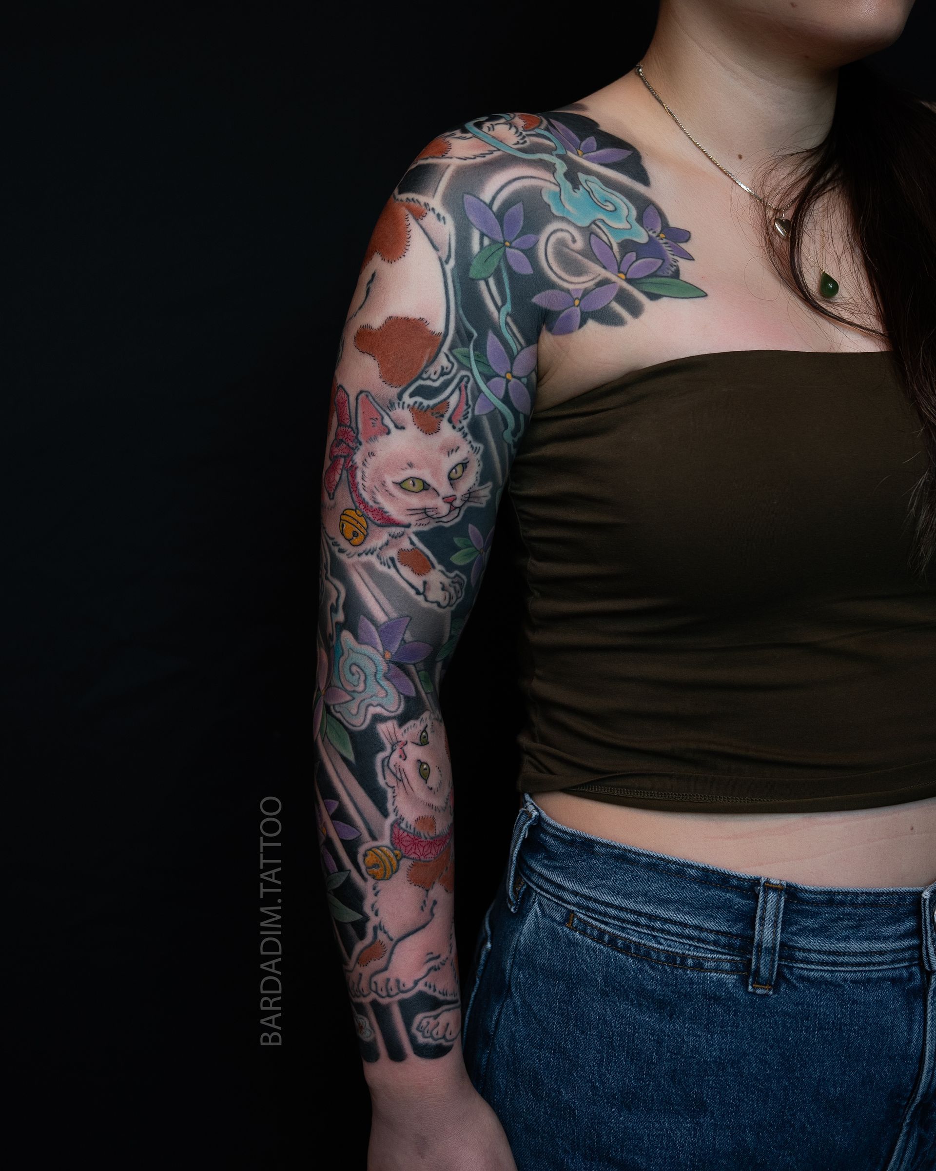 Side view Japanese sleeve tattoo showing monster cats and yama-ajisai flow