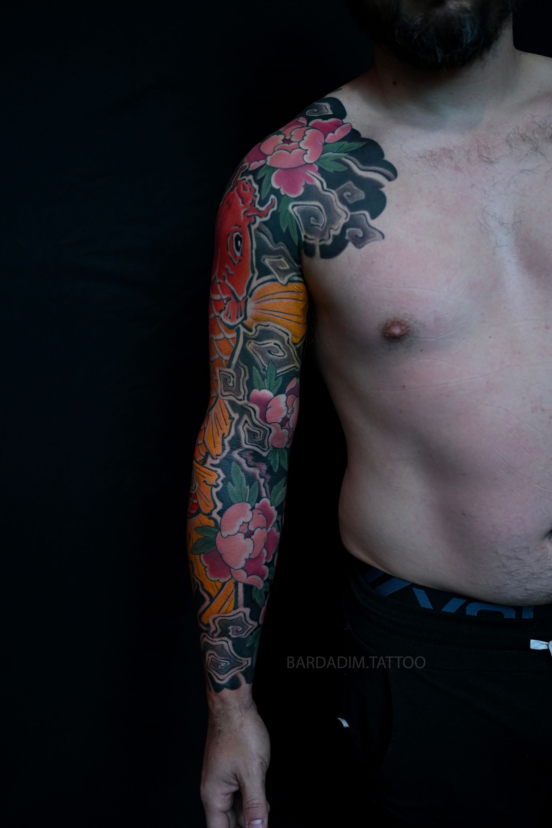 Orange koi Japanese sleeve tattoo with peonies front angle
