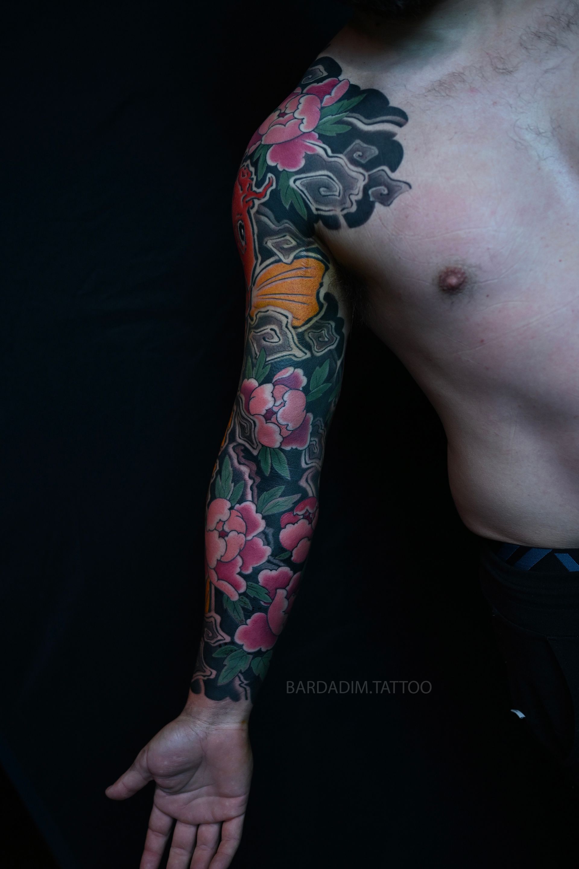Orange koi and peony Japanese sleeve tattoo side view