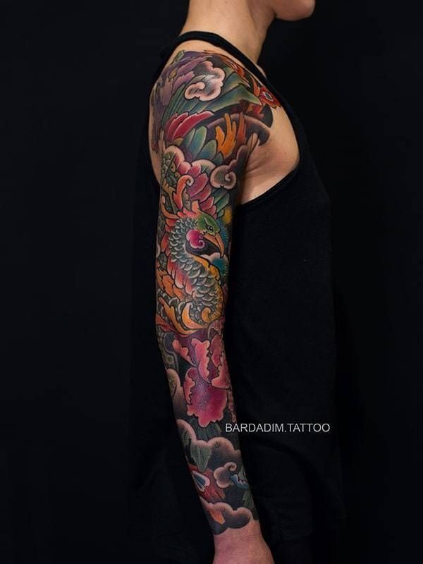 A man with a colorful tattoo on his arm and shoulder.