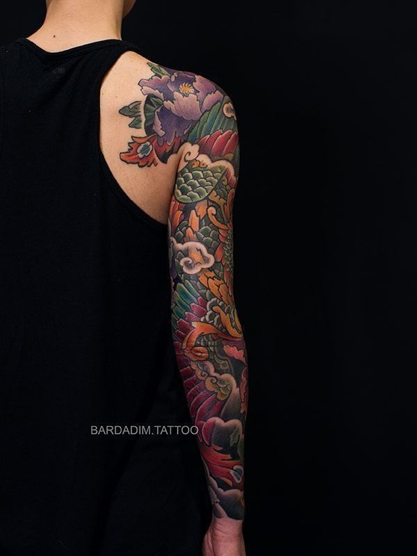 A man with a full sleeve tattoo on his arm.