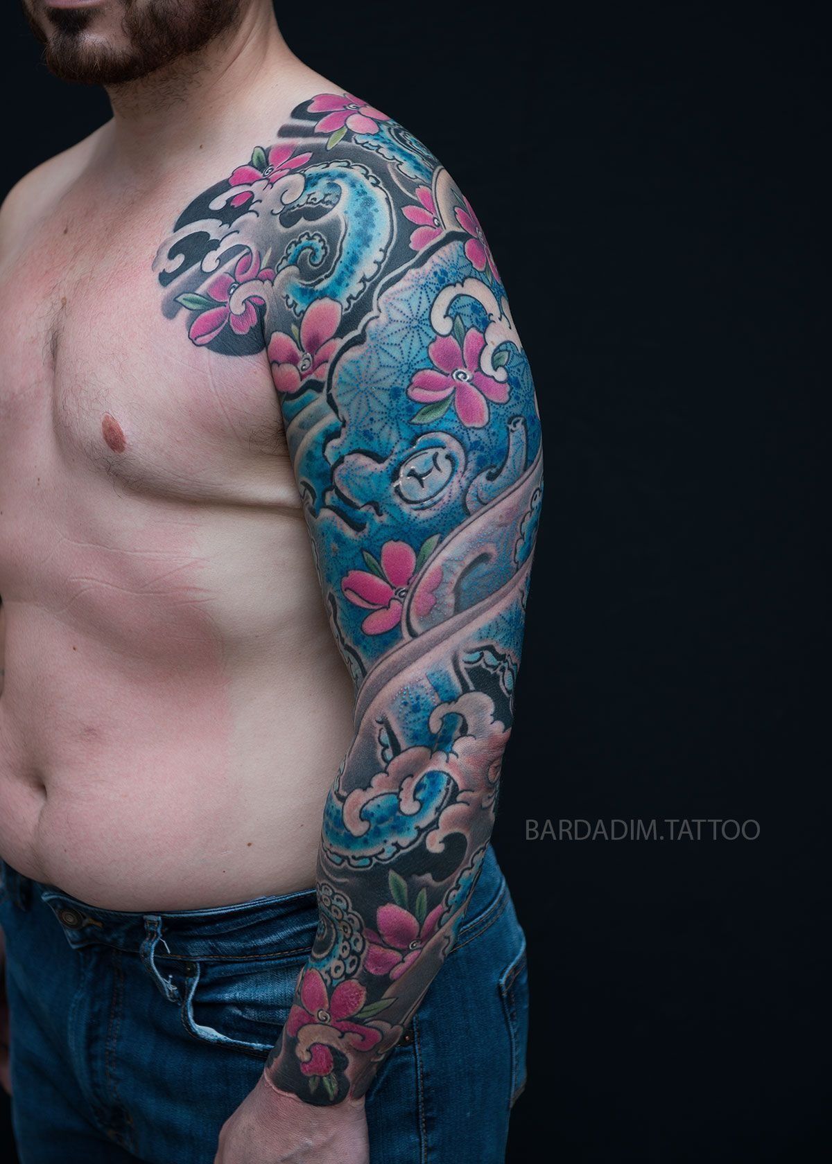 A man with a tattoo on his arm and chest.