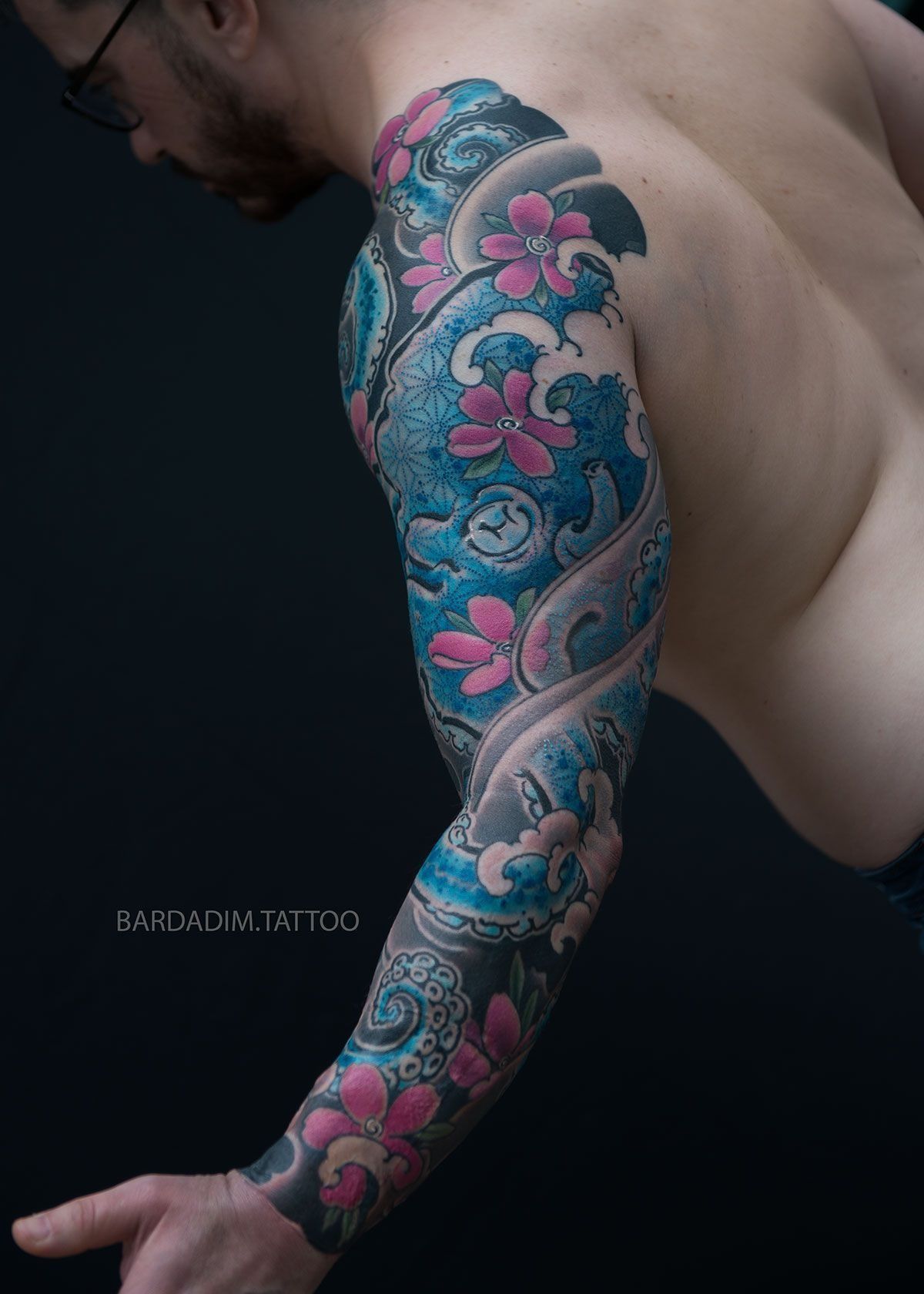 A man with a full sleeve tattoo on his arm.