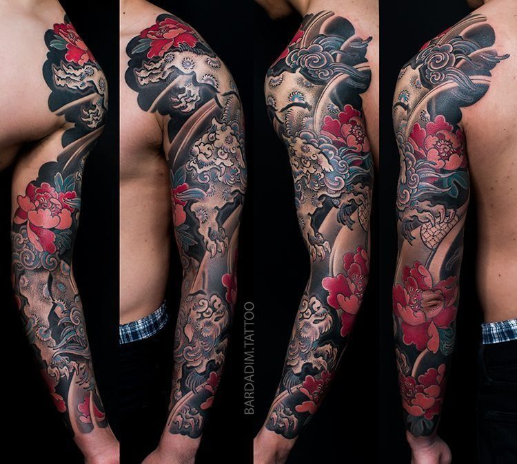 Full sleeve tattoo of red peonies and dark swirling clouds on an arm.