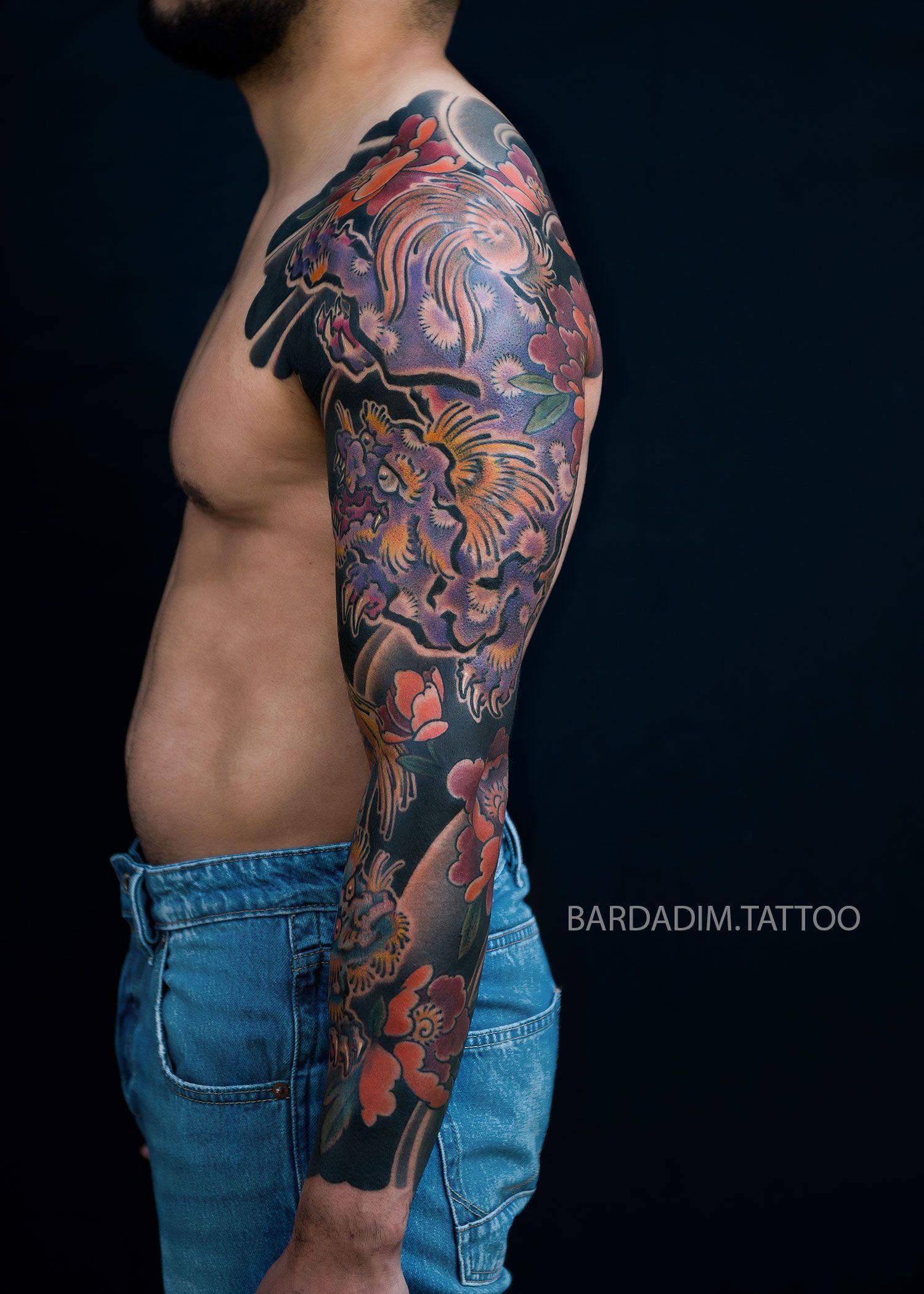 Focal point - Shishi Lion’s head surrounded by detailed peonies in a Japanese sleeve tattoo created by Bardadim Tattoo.