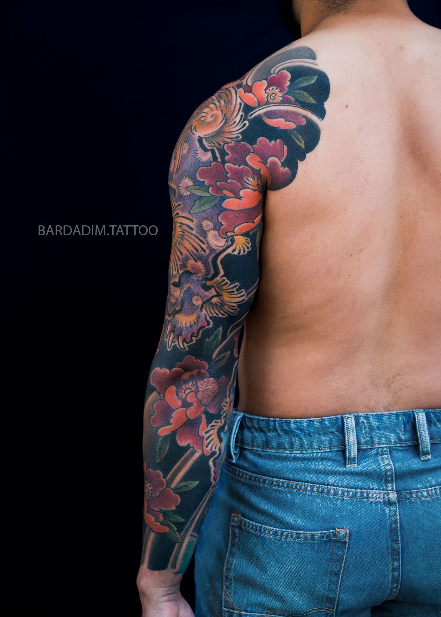 Back view of Irezumi sleeve with guardian lion and peony flowers symbolizing protection and prosperity.
