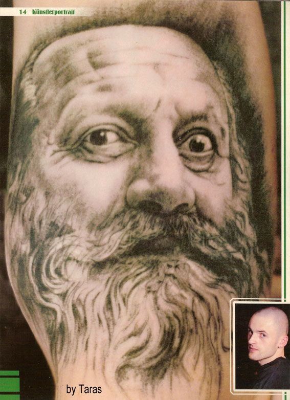 A man with a beard has a tattoo of his face on his arm