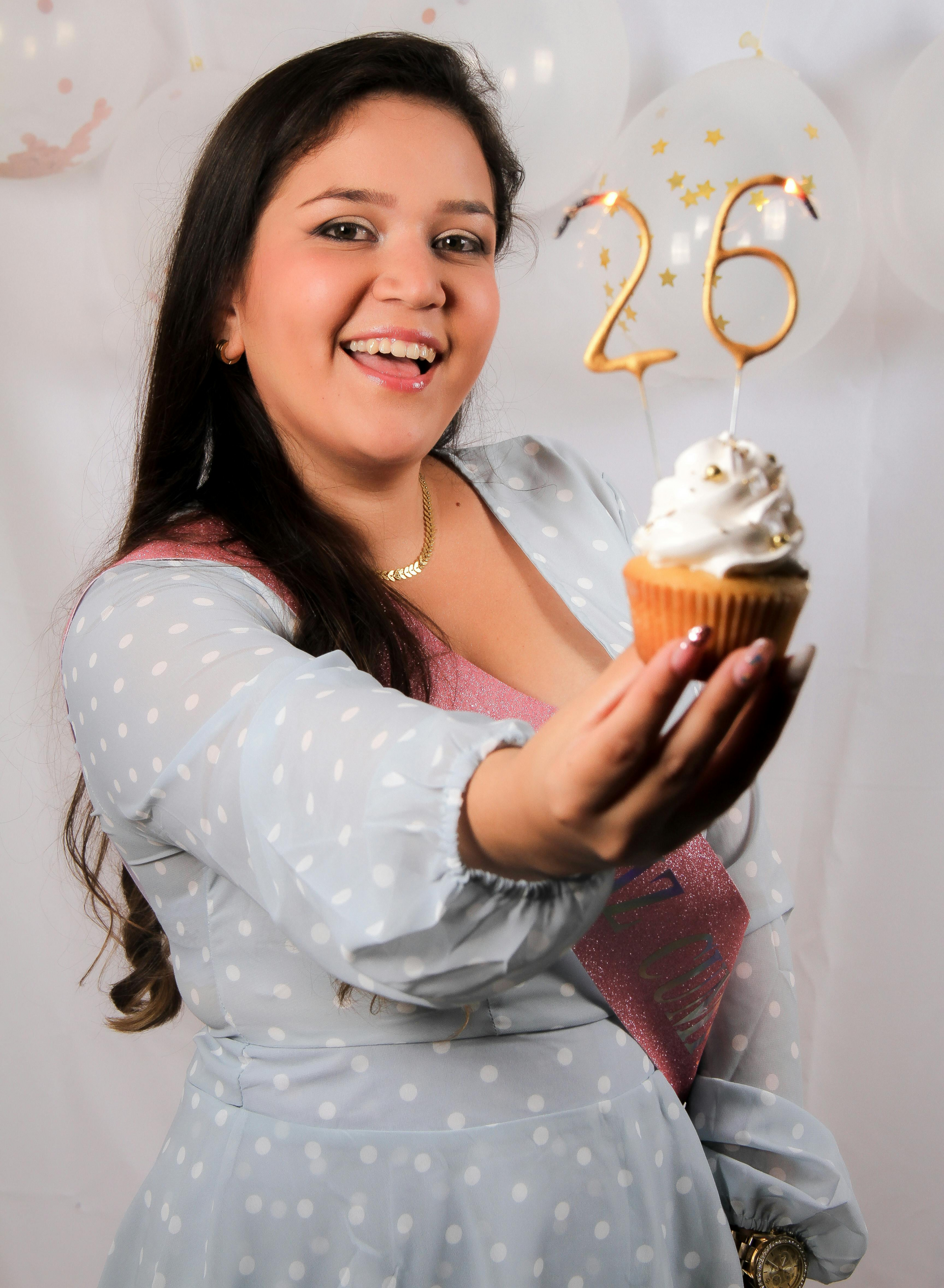 Woman holding a cupcake with a