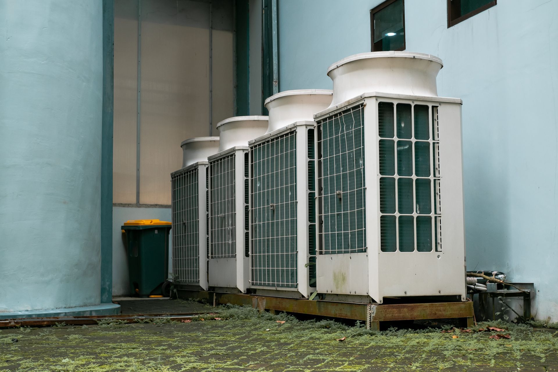 Row of large VRF commercial AC units installed outside a building for cooling and ventilation.