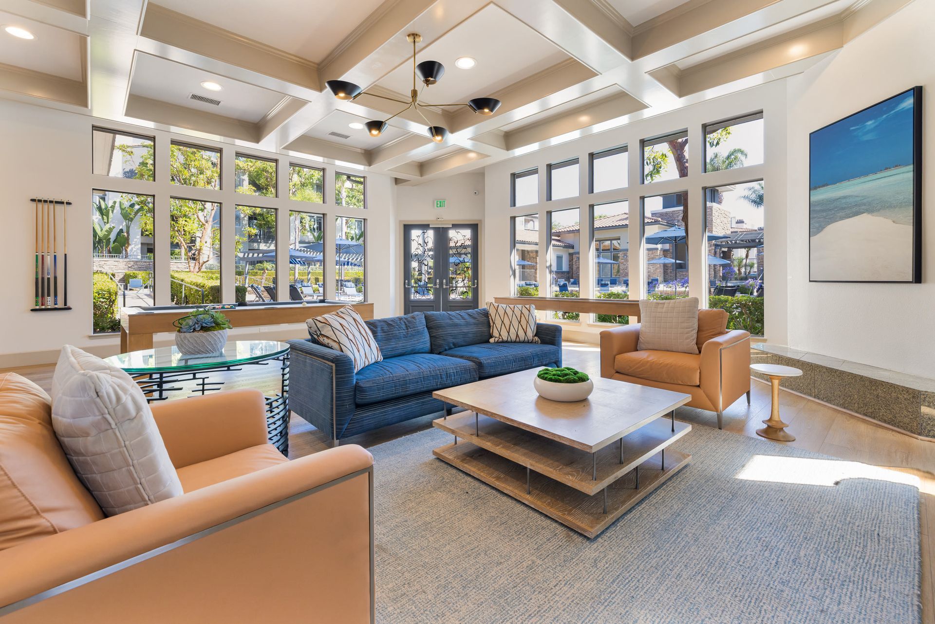 Bright lobby seating area in an apartment community with large grid windows and modern furniture at Alize Apartment Homes in Aliso Viejo, CA.